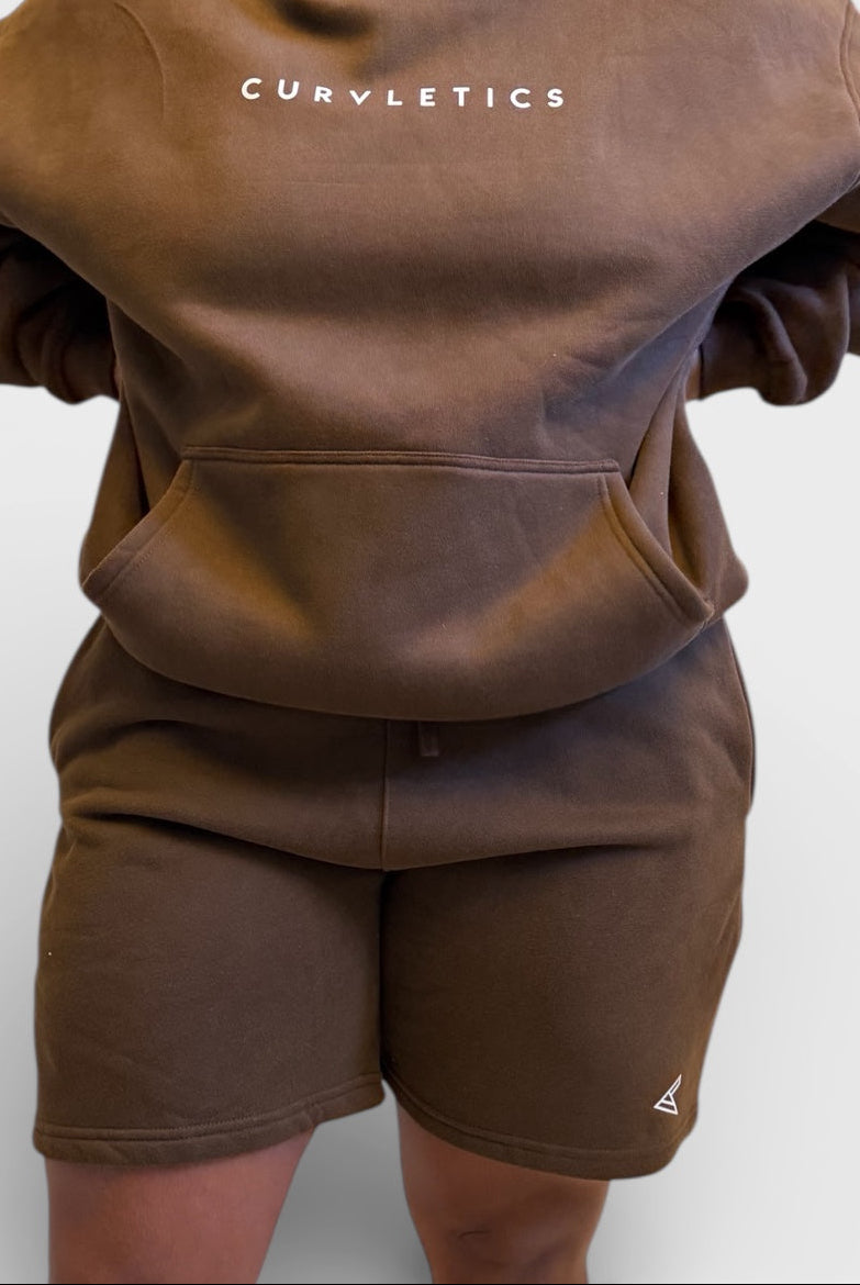 Brown hoodie and shorts set with 'Curvy Athletics' branding on a white background