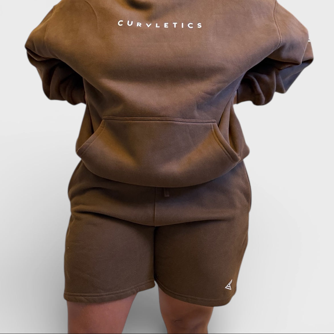 Brown hoodie and shorts set with 'Curvy Athletics' branding on a white background
