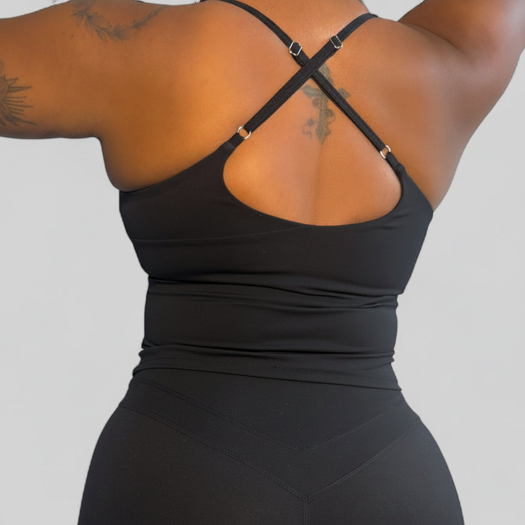 Person wearing a black athletic outfit on a plain background